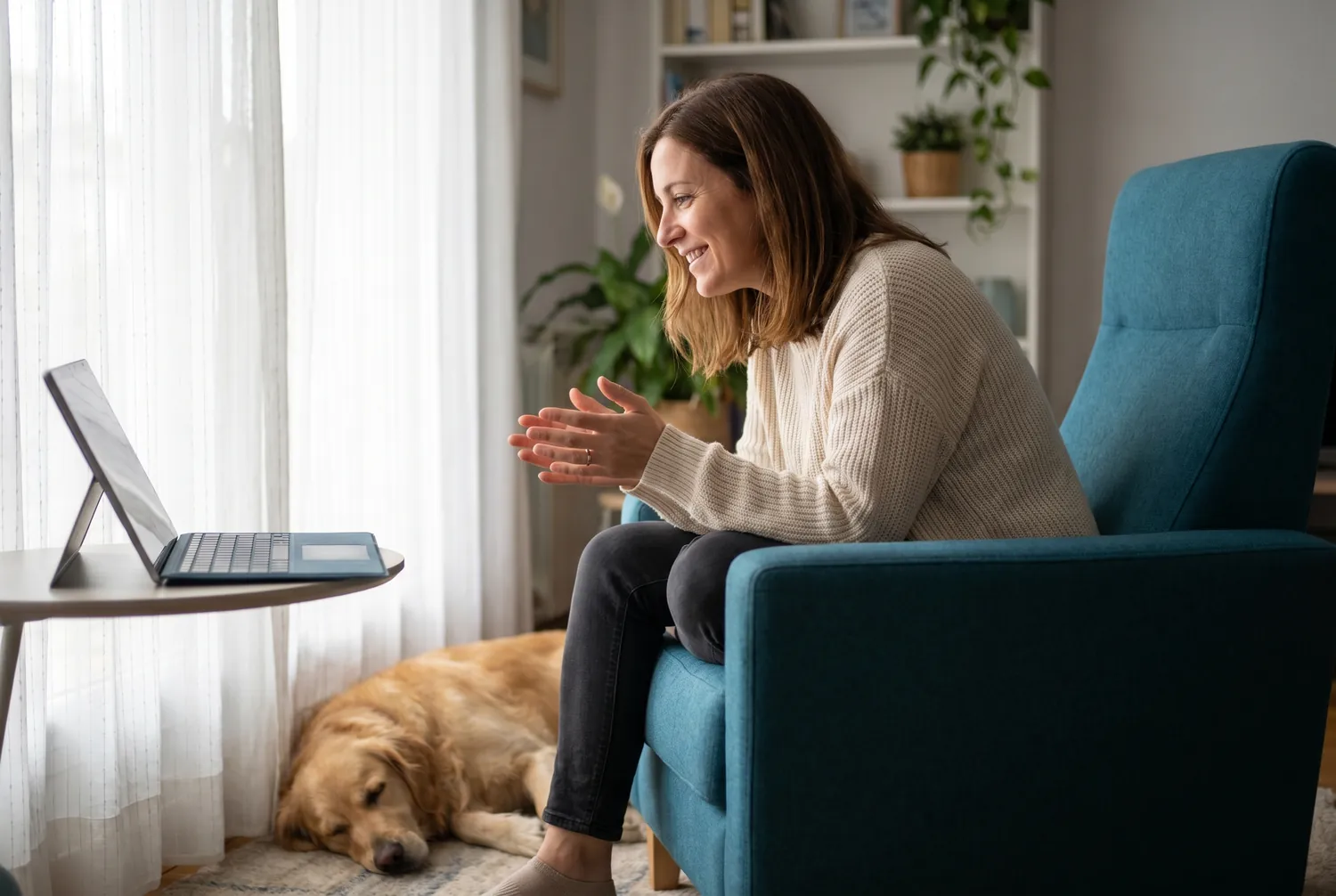 Woman at home in a teal armchair during an online psychiatry video visit