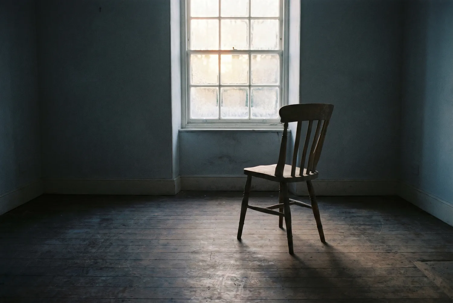 Low winter morning light through a frosted window into a quiet room