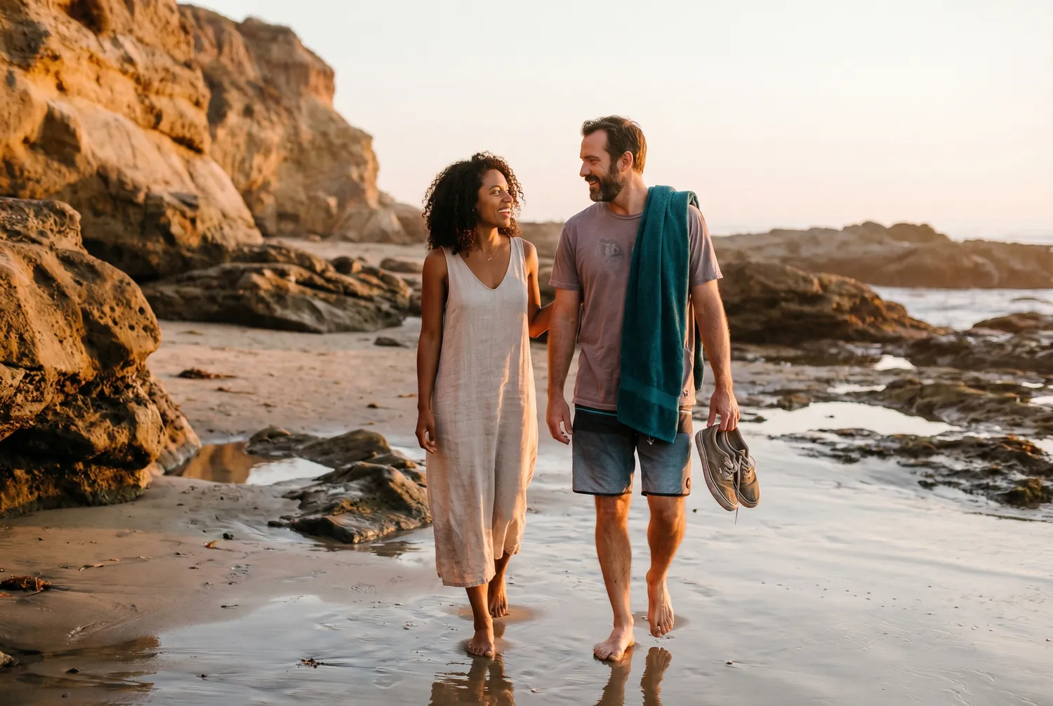 Couple walking a Corona del Mar cove at sunset in Newport Beach Couple walking a Corona del Mar cove at sunset in Newport Beach